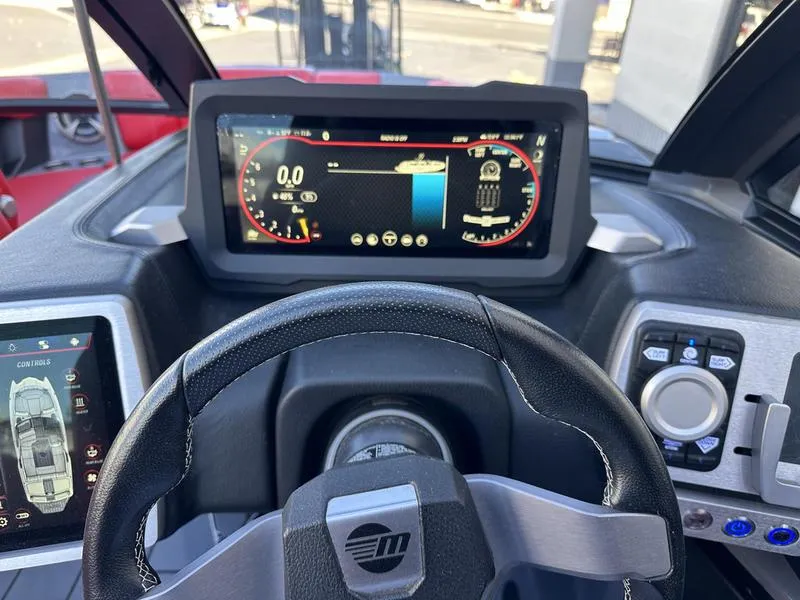 Slide: The Image of 2024 Malibu 23 MXZ dashboard with digital display and steering wheel. - 18