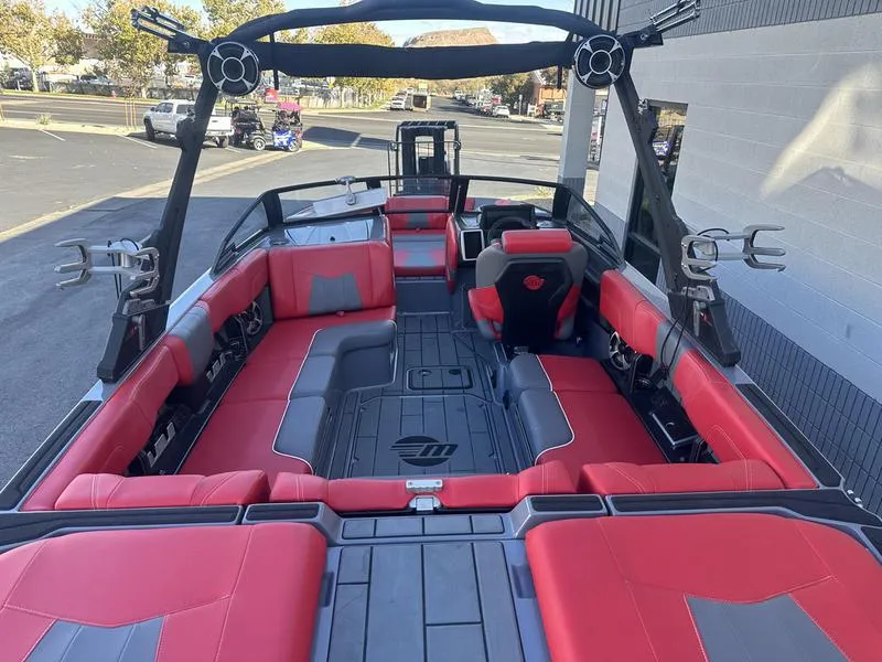 Slide: The Image of 2024 Malibu 23 MXZ boat interior with red and gray seating, modern design. - 6