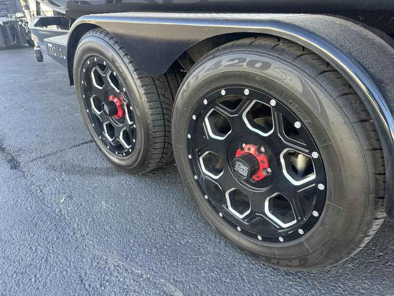 Slide: The Image of 2024 Malibu 23 MXZ trailer with black alloy wheels and red accents. - 7