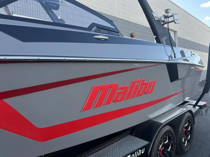 Slide: The Image of 2024 Malibu 23 MXZ boat with sleek gray and red design. - 8