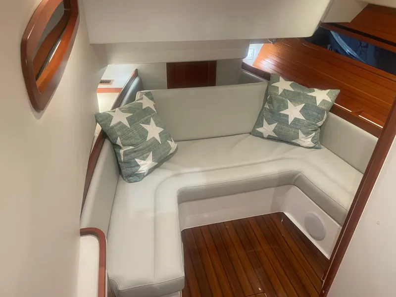 Slide: The Image of 2023 MJM 4 boat interior with star-patterned cushions and wooden flooring. - 11