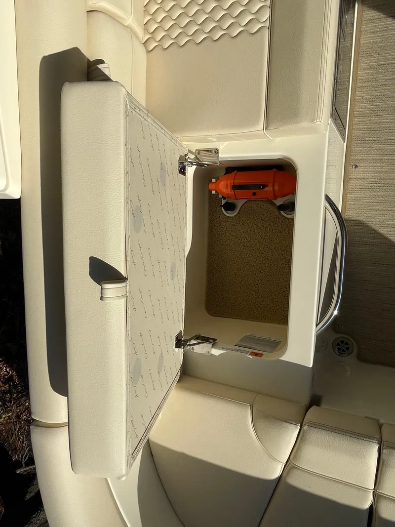 Slide: The Image of 2025 Chris-Craft Launch 28GT boat storage compartment with safety equipment. - 11