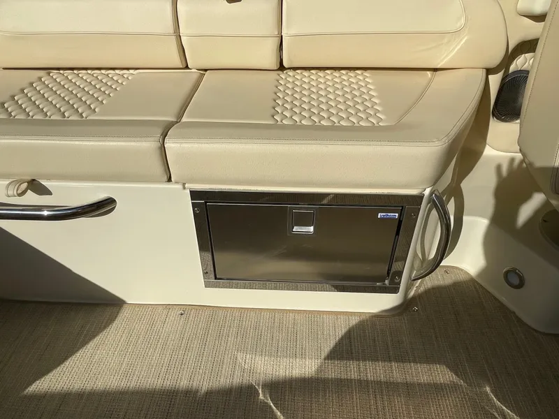 Slide: The Image of 2025 Chris-Craft Launch 28GT interior seating with storage compartment. - 12