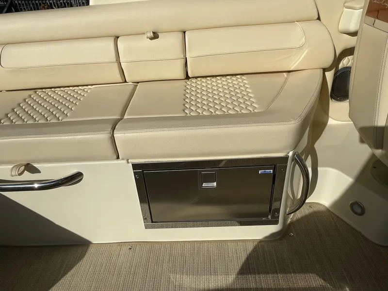Slide: The Image of 2025 Chris-Craft Launch 28GT interior seating with storage compartment. - 13