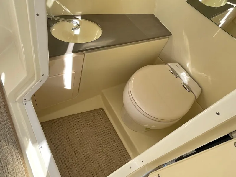 Slide: The Image of 2025 Chris-Craft Launch 28GT boat bathroom with modern sink and toilet. - 19