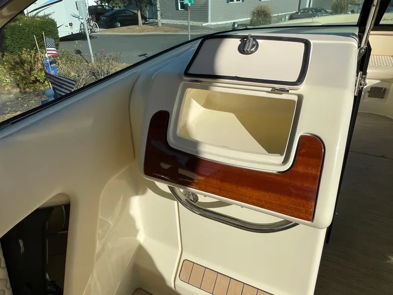 Slide: The Image of 2025 Chris-Craft Launch 28GT interior with open storage compartment and wood accents. - 20