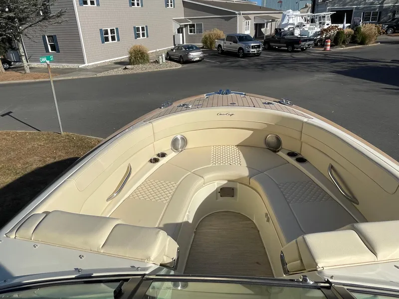 Slide: The Image of 2025 Chris-Craft Launch 28GT boat with luxurious seating in a marina setting. - 24