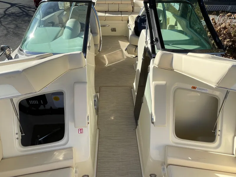 Slide: The Image of 2025 Chris-Craft Launch 28GT interior with beige seating and dual consoles. - 25