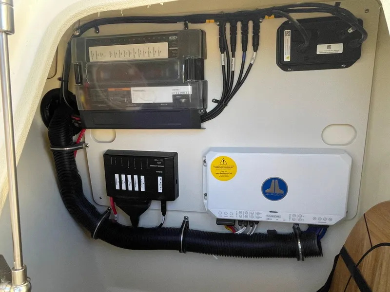 Slide: The Image of Electrical panel inside 2025 Chris-Craft Launch 28GT boat, showcasing wiring and control systems. - 26