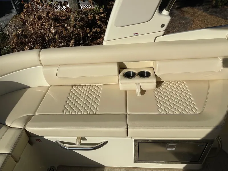 Slide: The Image of Luxurious seating on 2025 Chris-Craft Launch 28GT with quilted upholstery and cup holders. - 9