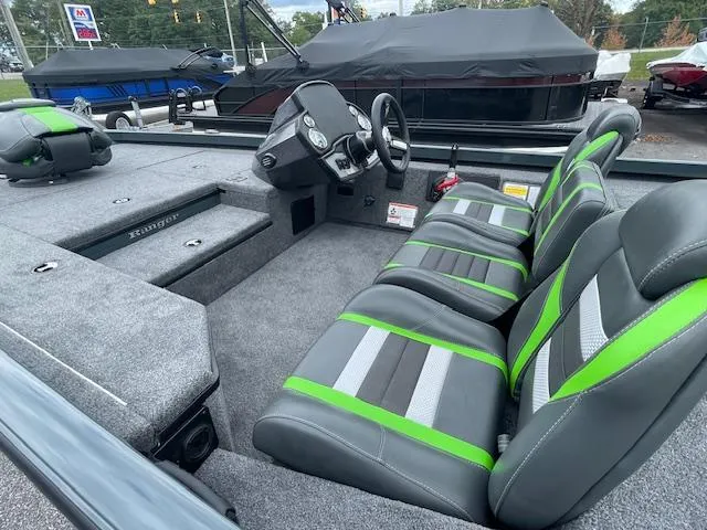 Slide: The Image of 2025 Ranger RT178 boat interior with gray and green seats, steering wheel, and dashboard. - 10