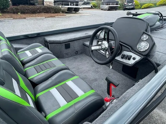 Slide: The Image of 2025 Ranger RT178 boat interior with green and black seats, steering wheel, and dashboard. - 11