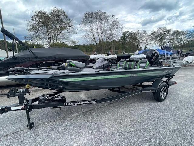 Slide: The Image of 2025 Ranger RT178 fishing boat on trailer, parked outdoors under cloudy sky. - 3