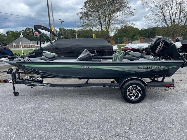 Slide: The Image of 2025 Ranger RT178 fishing boat on trailer, parked outdoors. - 6