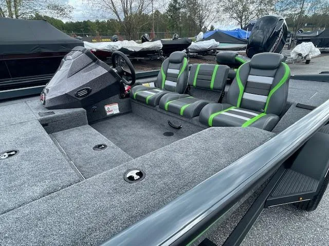 Slide: The Image of 2025 Ranger RT178 boat interior with gray and green seating, steering console, and spacious deck. - 8