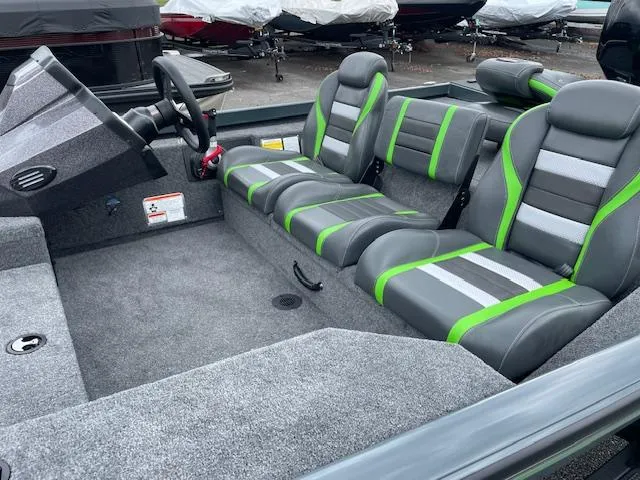 Slide: The Image of 2025 Ranger RT178 boat interior with gray and green seating, steering wheel, and carpeted flooring. - 9