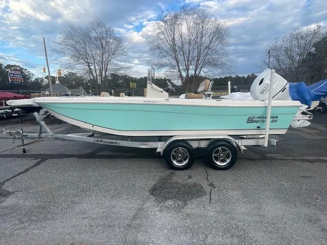 Slide: The Image of 2023 Carolina Skiff 21 Ultra Elite boat on trailer, parked outdoors. - 1