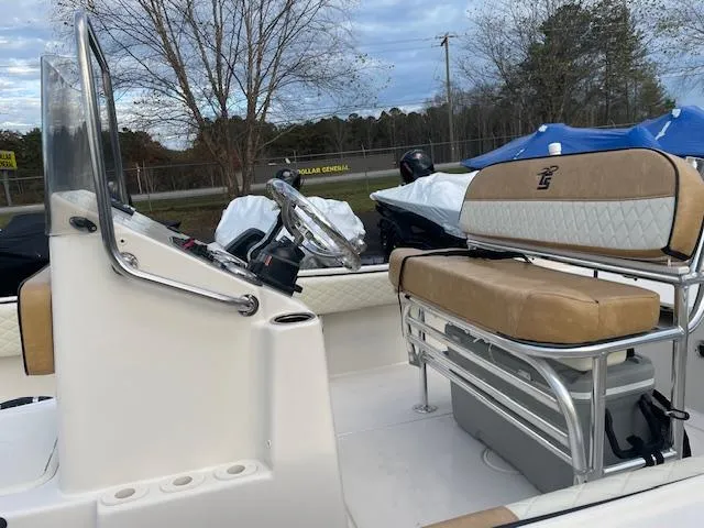 Slide: The Image of 2023 Carolina Skiff 21 Ultra Elite boat interior with tan seating and steering console. - 5