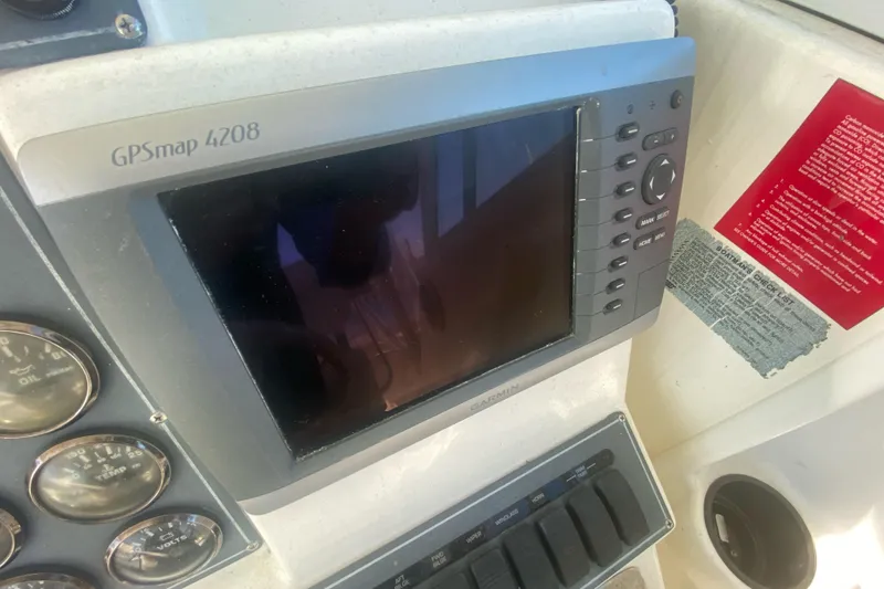 Slide: The Image of GPSmap 4208 on 2000 Rampage 30 Offshore boat dashboard with gauges and controls. - 5