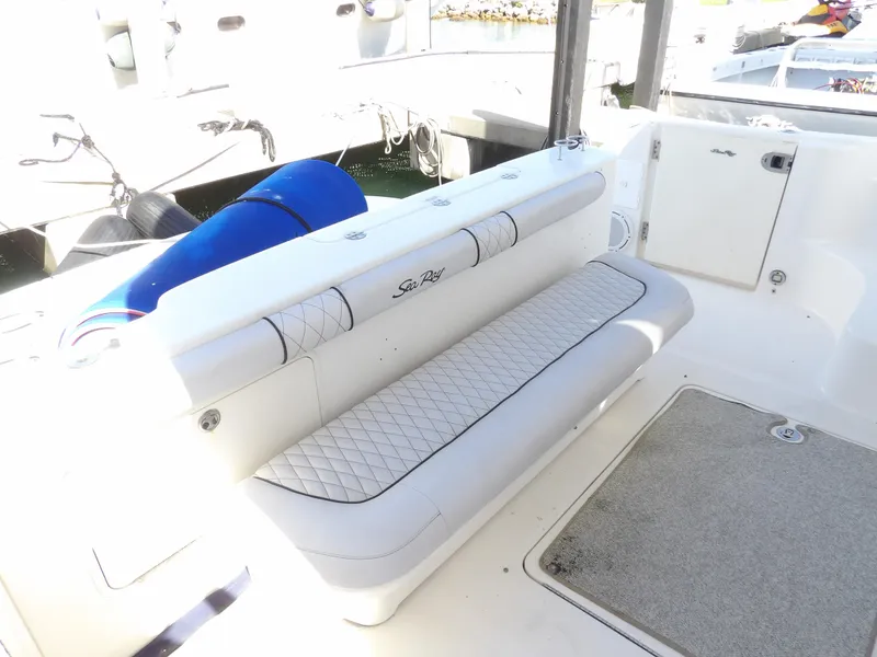 Slide: The Image of 2008 Sea Ray 44 Sedan Bridge boat seating area with white cushioned bench. - 10