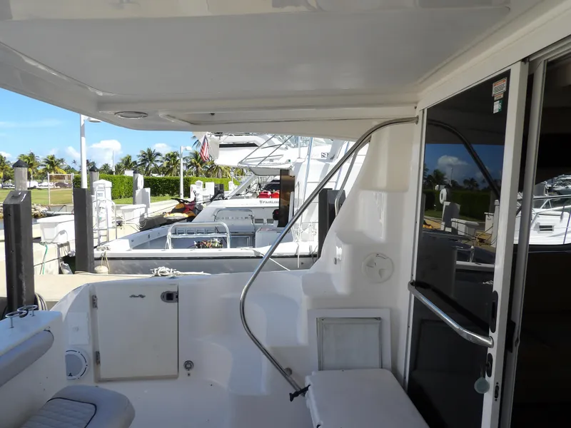 Slide: The Image of 2008 Sea Ray 44 Sedan Bridge yacht docked, featuring spacious deck and modern amenities. - 11