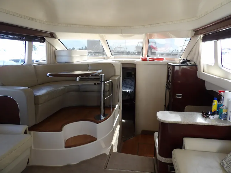 Slide: The Image of Interior of 2008 Sea Ray 44 Sedan Bridge yacht with seating and windows. - 15