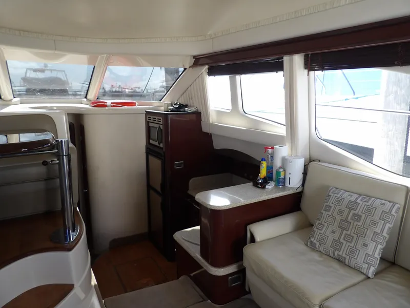 Slide: The Image of Interior of 2008 Sea Ray 44 Sedan Bridge yacht with modern seating and windows. - 17
