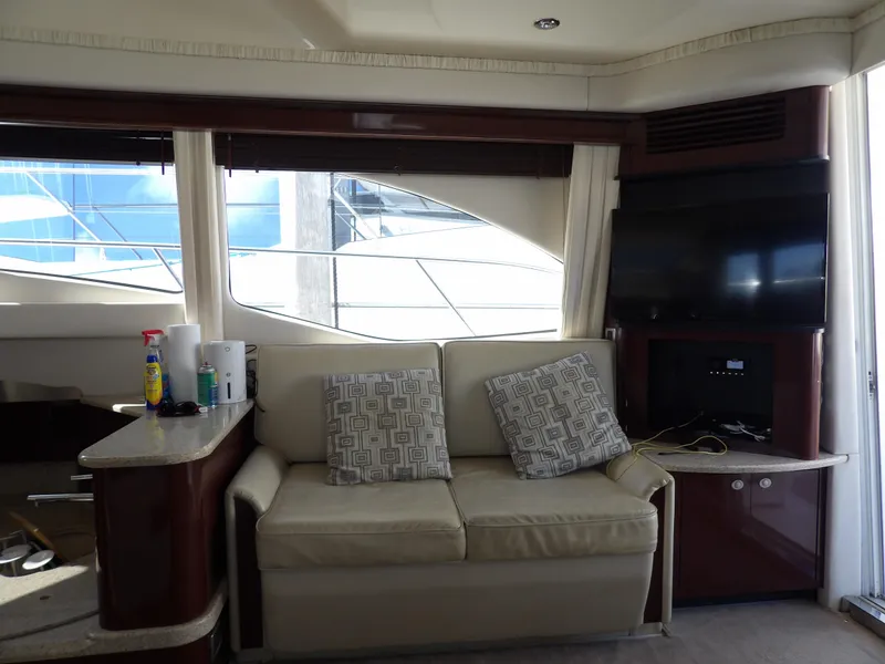 Slide: The Image of Interior of 2008 Sea Ray 44 Sedan Bridge yacht with sofa and TV. - 19