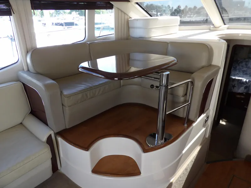 Slide: The Image of Luxurious 2008 Sea Ray 44 Sedan Bridge interior with elegant seating and table. - 26