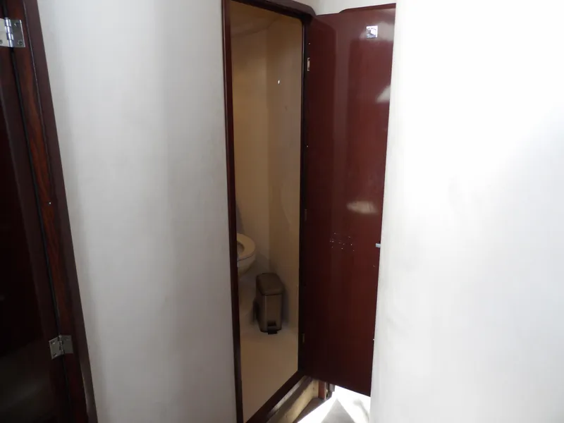 Slide: The Image of 2008 Sea Ray 44 Sedan Bridge bathroom interior with wooden door. - 40