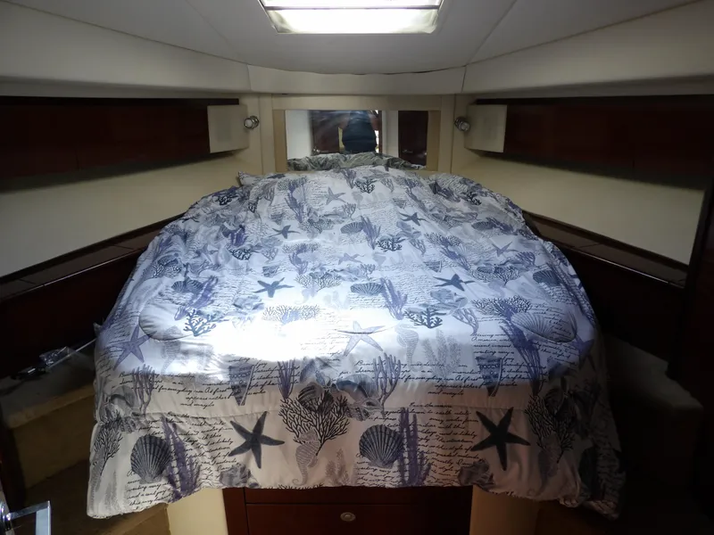 Slide: The Image of Luxurious 2008 Sea Ray 44 Sedan Bridge cabin with nautical-themed bedding. - 46