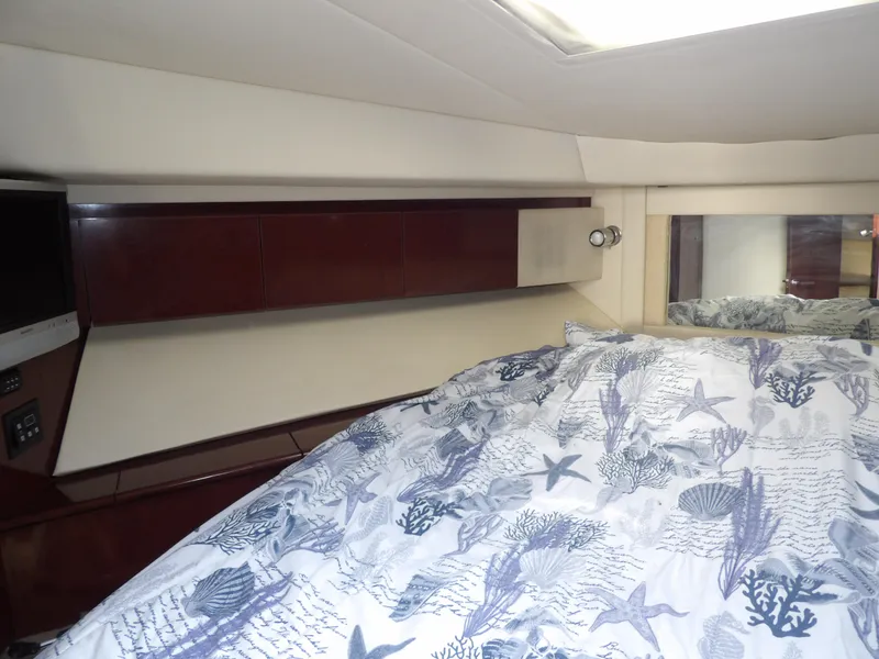 Slide: The Image of Luxurious 2008 Sea Ray 44 Sedan Bridge cabin interior with elegant bedding and wood cabinetry. - 48