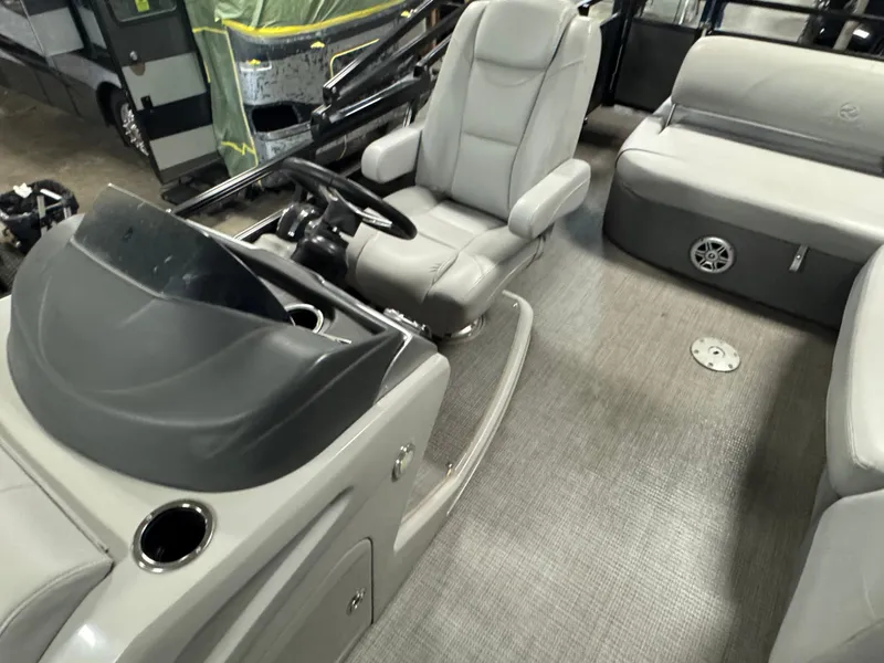 Slide: The Image of 2019 Regency 250 DL3 boat interior with gray seating and steering console. - 10