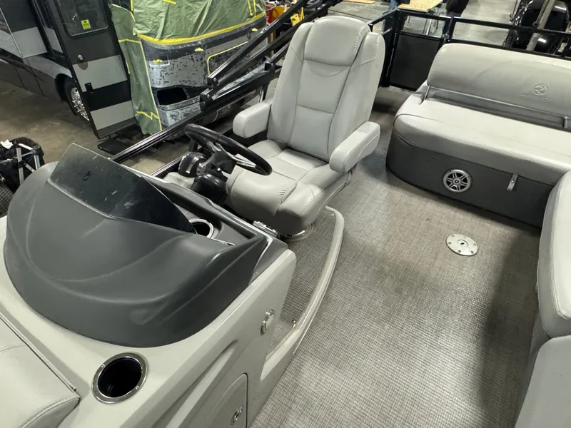 Slide: The Image of 2019 Regency 250 DL3 boat interior with gray seating and steering console. - 11