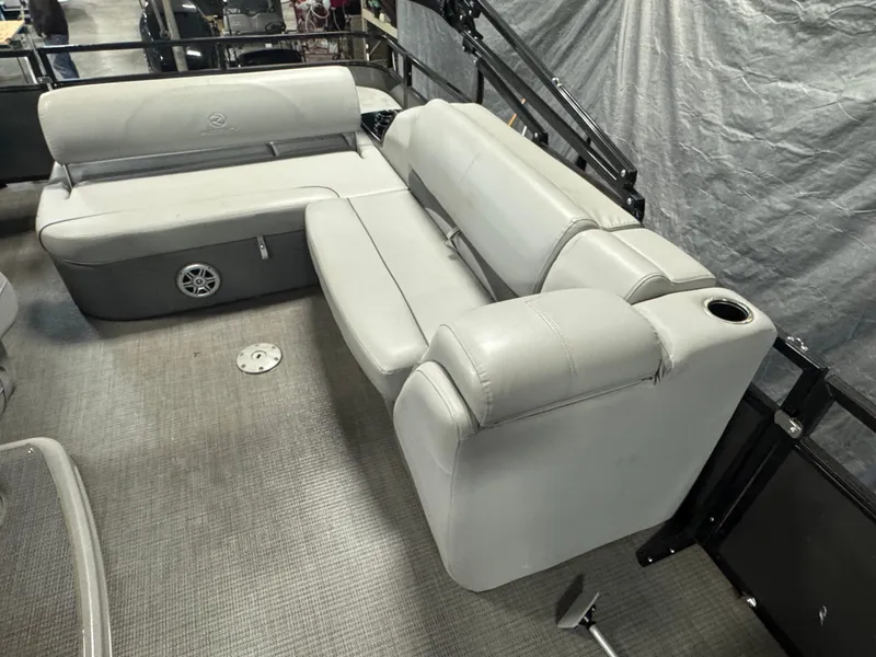 Slide: The Image of 2019 Regency 250 DL3 pontoon boat interior with gray seating and cup holder. - 12