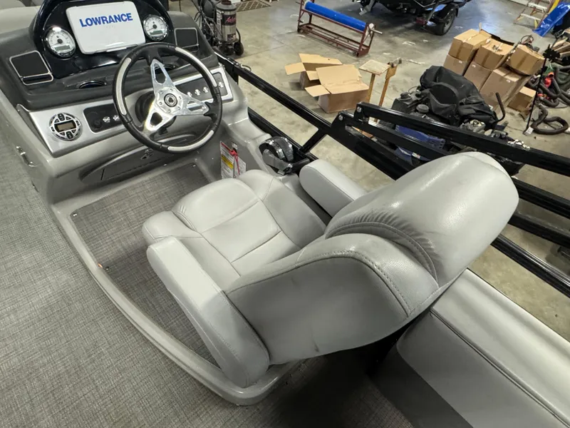 Slide: The Image of 2019 Regency 250 DL3 boat interior with steering wheel and captain's chair. - 18