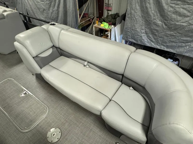 Slide: The Image of 2019 Regency 250 DL3 boat interior with gray seating and carpeted flooring. - 9