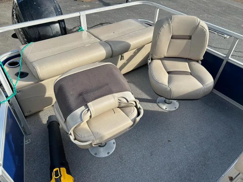 Slide: The Image of 2017 Sun Tracker Fish Barge 22 DLC interior with beige seating and deck. - 4