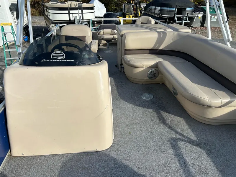 Slide: The Image of 2017 Sun Tracker Fish Barge 22 DLC interior with beige seating and steering console. - 5