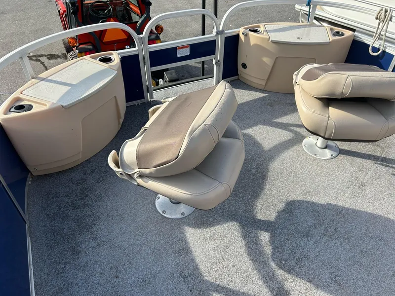 Slide: The Image of 2017 Sun Tracker Fish Barge 22 DLC interior with swivel seats and storage compartments. - 6