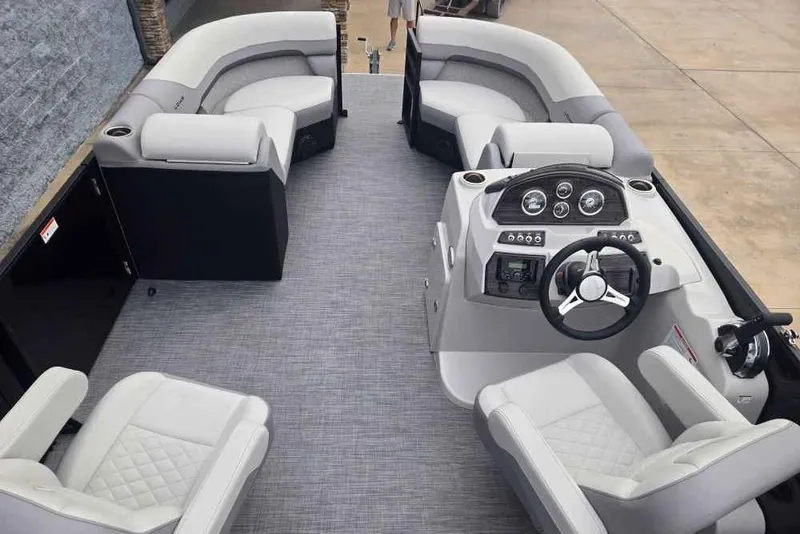 Slide: The Image of 2025 Lowe SS 230 WV boat interior with plush seating and modern dashboard. - 6