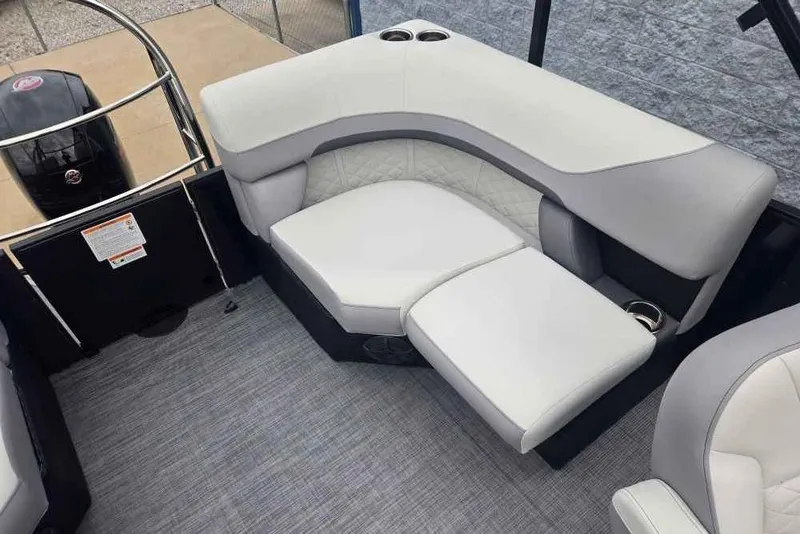Slide: The Image of 2025 Lowe SS 230 WV boat interior with white cushioned seating and cup holders. - 7