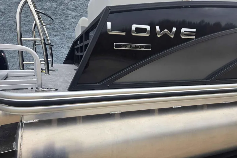 Slide: The Image of 2025 Lowe SS 230 WV pontoon boat, sleek black design, side view. - 9