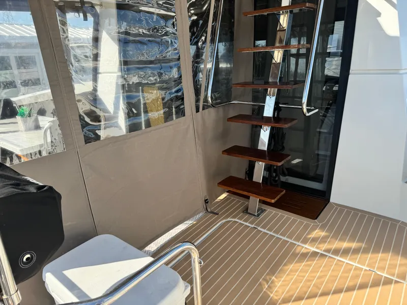 Slide: The Image of Interior view of 2017 Fountaine Pajot MY 37 yacht with wooden steps and seating. - 23