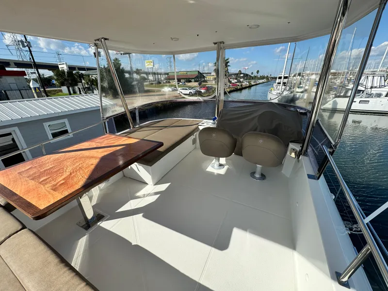 Slide: The Image of 2017 Fountaine Pajot MY 37 yacht deck with seating and table, marina view. - 32