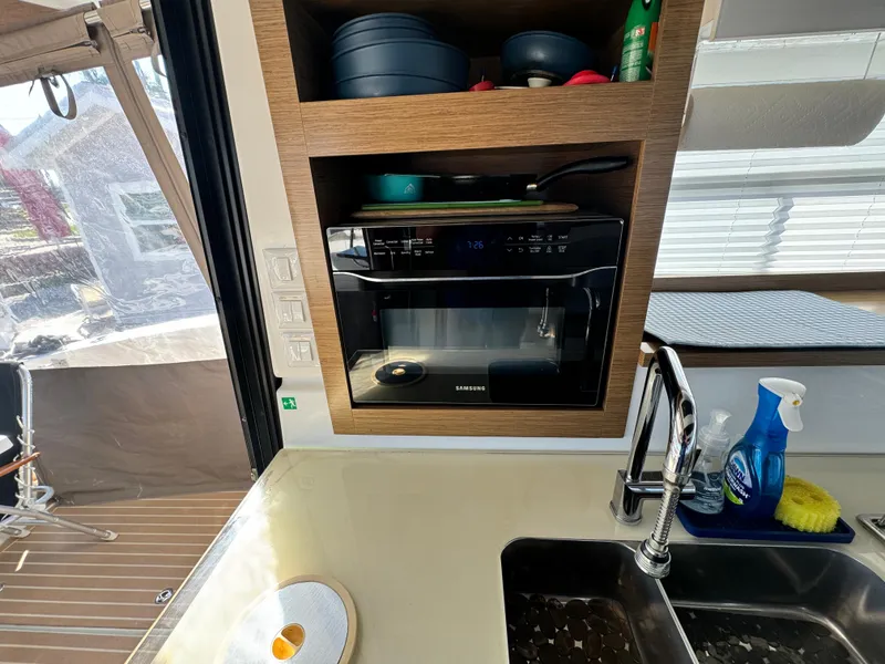 Slide: The Image of Modern kitchen area on 2017 Fountaine Pajot MY 37 yacht with microwave and sink. - 16