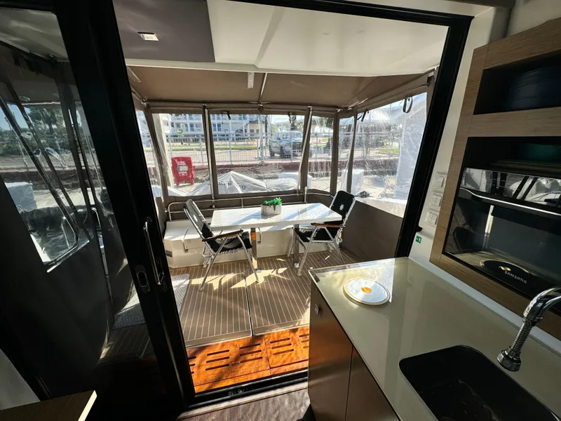 Slide: The Image of Interior view of 2017 Fountaine Pajot MY 37 yacht, featuring a cozy dining area. - 18