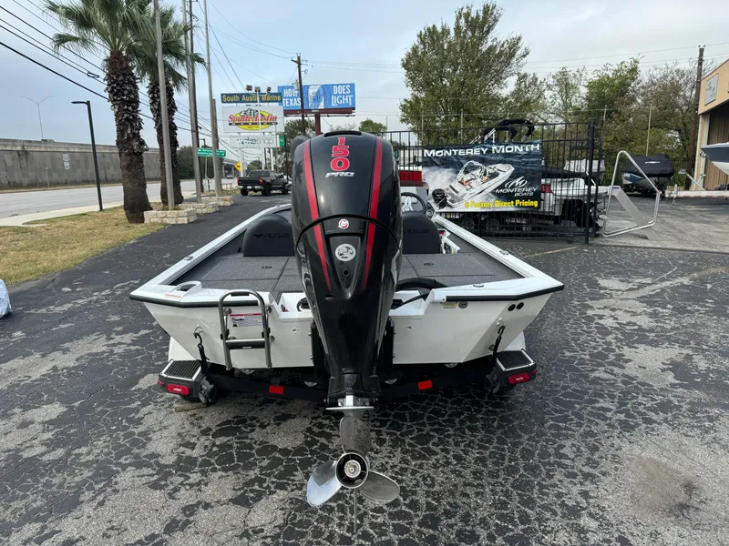 Slide: The Image of 2025 Vexus AVX1980 boat with powerful outboard motor, parked outdoors. - 2