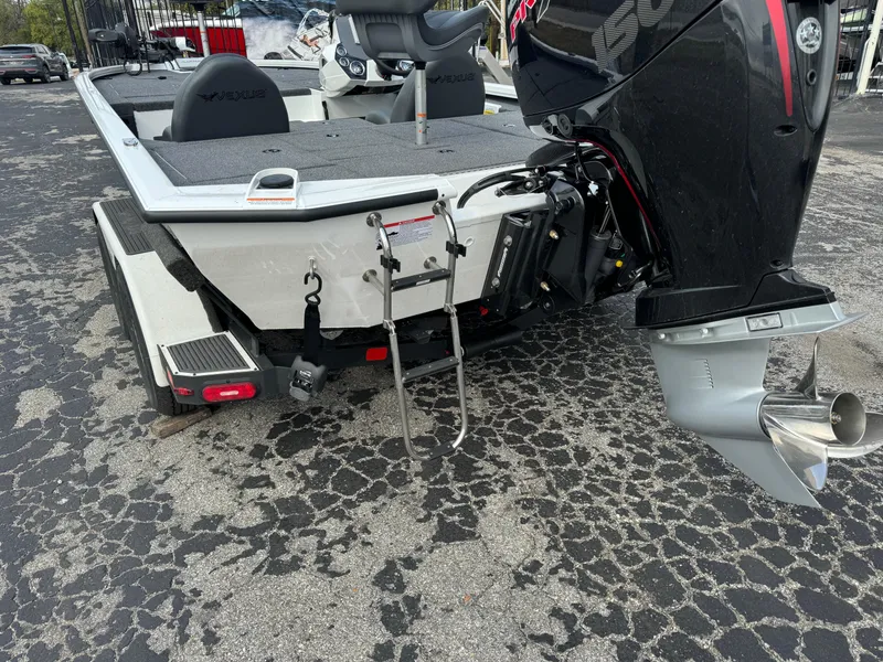 Slide: The Image of 2025 Vexus AVX1980 boat rear view with motor and ladder on asphalt. - 3