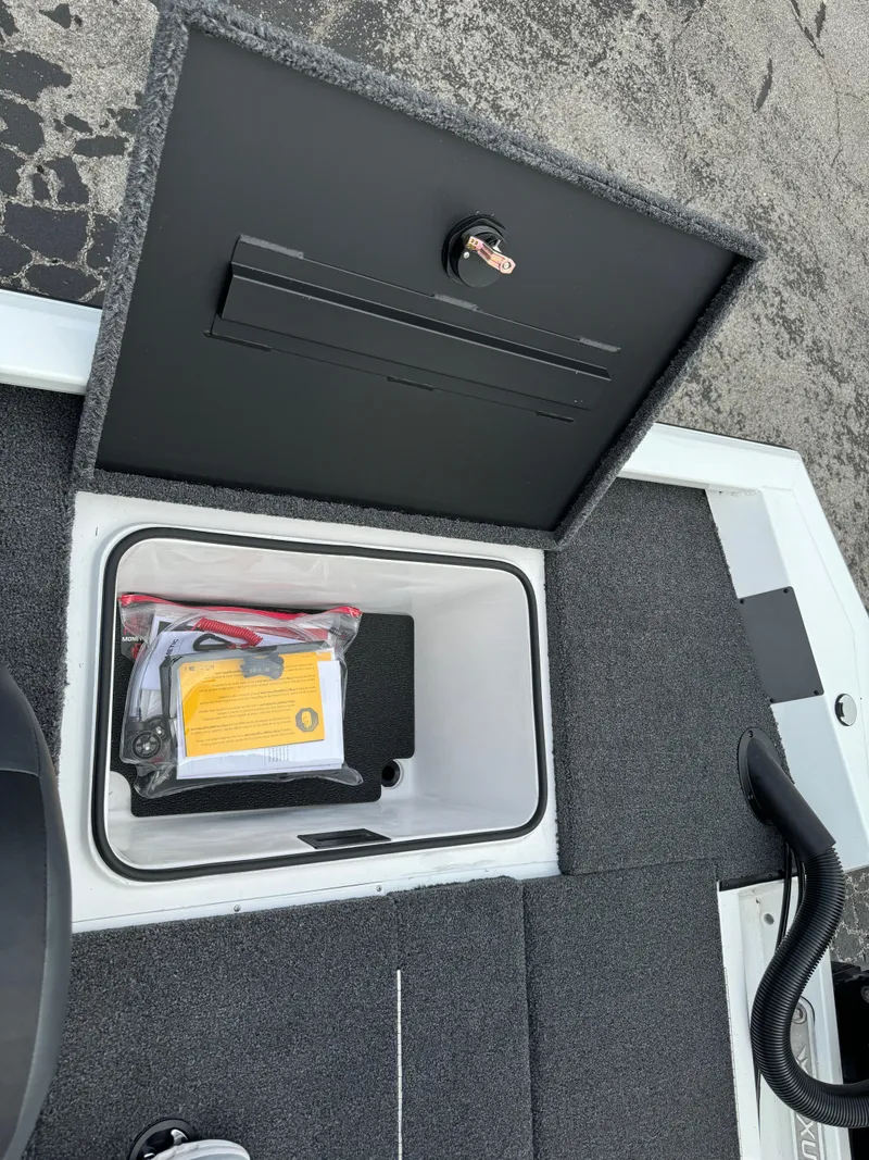 Slide: The Image of Open storage compartment in 2025 Vexus AVX1980 boat, showing interior and contents. - 31